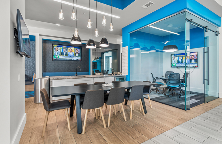 View of a large table and TV in the background